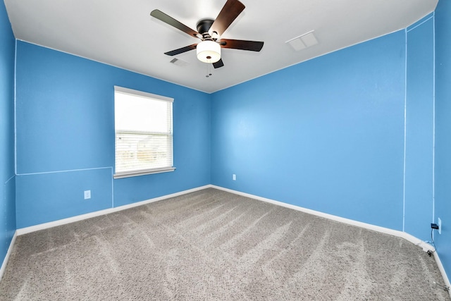 spare room featuring visible vents, baseboards, ceiling fan, and carpet floors