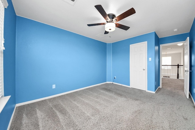 unfurnished bedroom with carpet, baseboards, and ceiling fan