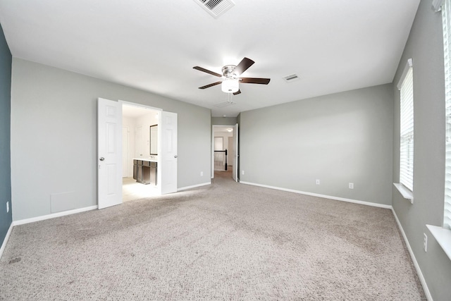 unfurnished bedroom with ceiling fan, carpet, visible vents, and baseboards