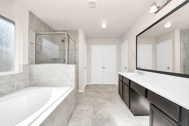 bathroom with a bath, visible vents, a shower stall, and a closet