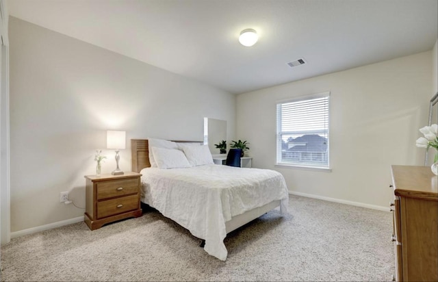 bedroom with baseboards, visible vents, and light carpet