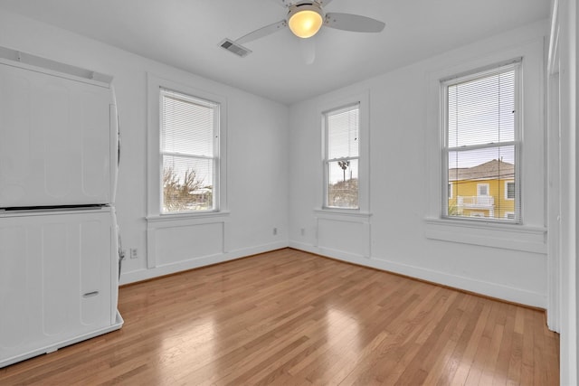 unfurnished room featuring visible vents, ceiling fan, baseboards, and light wood-style floors