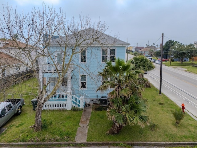 exterior space featuring a front lawn and fence