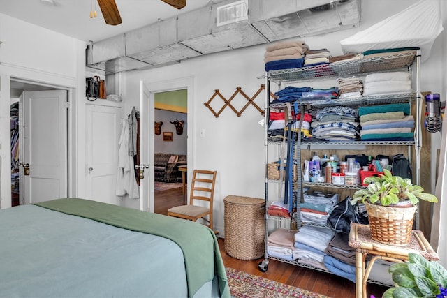 bedroom featuring visible vents and wood finished floors