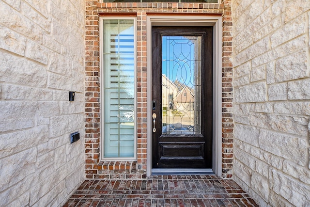 property entrance with stone siding