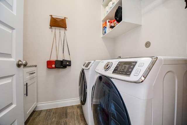 laundry room featuring baseboards, dark wood-type flooring, laundry area, and washer and clothes dryer