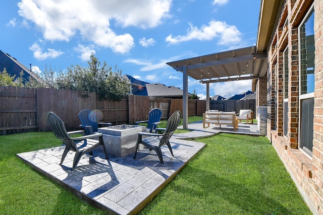 view of yard with a patio area, a fenced backyard, and an outdoor fire pit