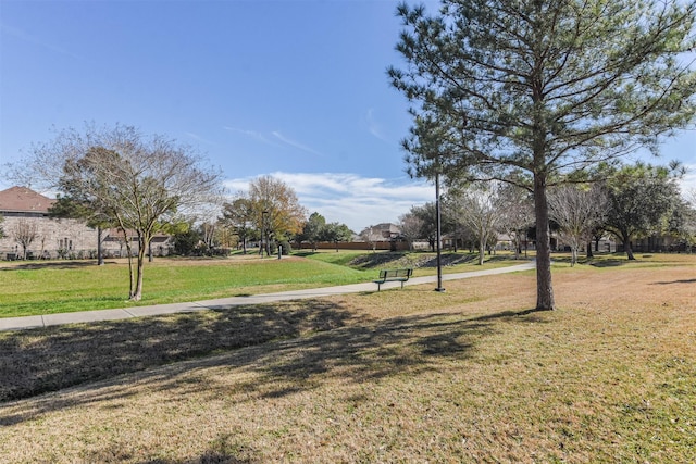 view of property's community with a lawn