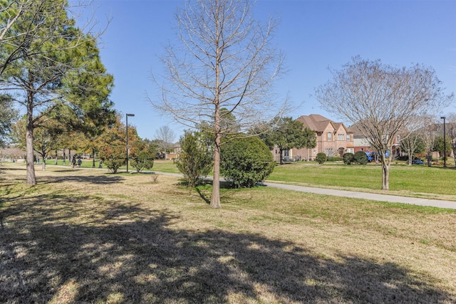 view of property's community with a yard