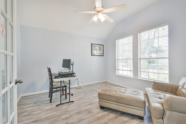 office area with ceiling fan, baseboards, light wood-style floors, and vaulted ceiling