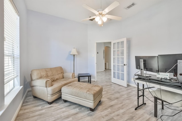 interior space with visible vents, baseboards, ceiling fan, french doors, and wood finished floors