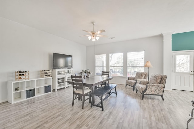 dining room featuring ceiling fan, a healthy amount of sunlight, and wood finished floors