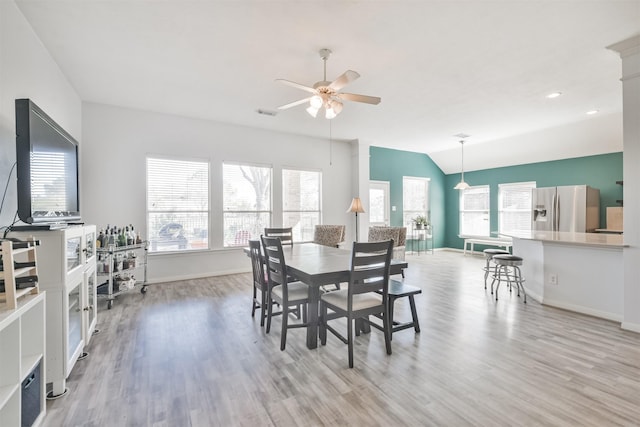 dining room with a wealth of natural light, light wood-style floors, and a ceiling fan