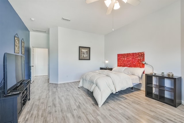 bedroom featuring ceiling fan, visible vents, baseboards, and light wood-style flooring