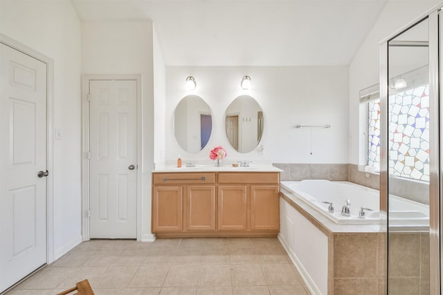 full bath with a bath, tile patterned flooring, and double vanity