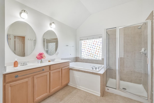 bathroom featuring a sink, a shower stall, tile patterned floors, and vaulted ceiling