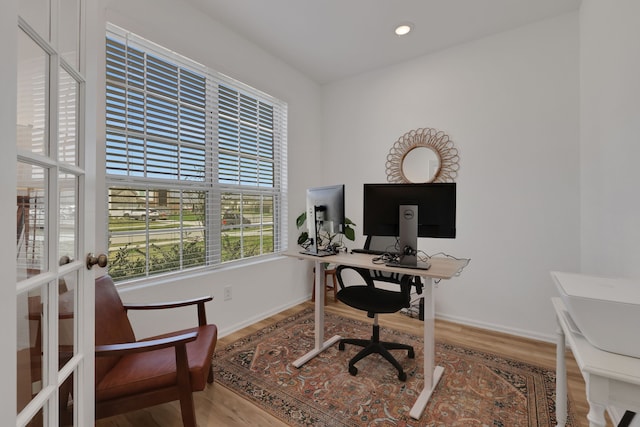 home office with wood finished floors, baseboards, and french doors