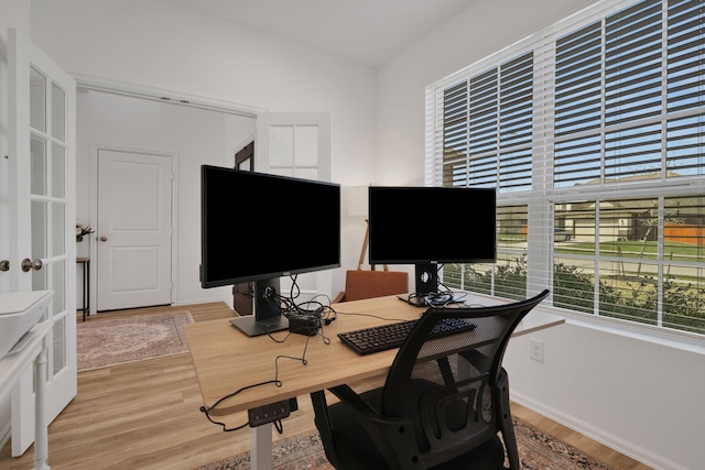 office with light wood-style flooring and baseboards