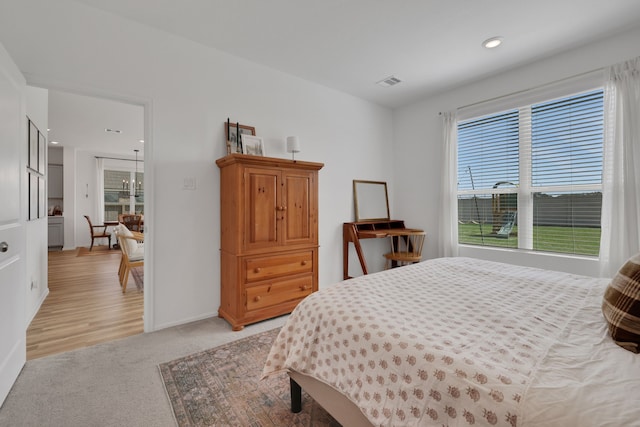 bedroom featuring recessed lighting, baseboards, visible vents, and light carpet