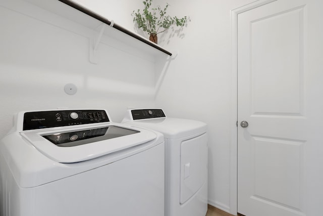 clothes washing area featuring independent washer and dryer and laundry area