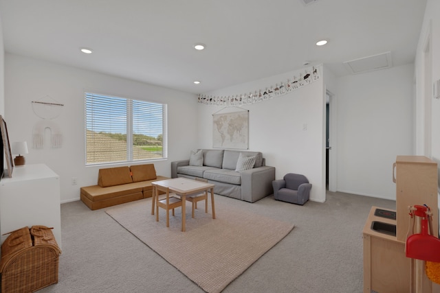 living room featuring recessed lighting, attic access, baseboards, and carpet floors