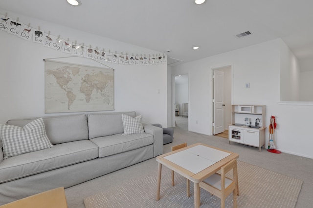 living area with recessed lighting, visible vents, and carpet floors