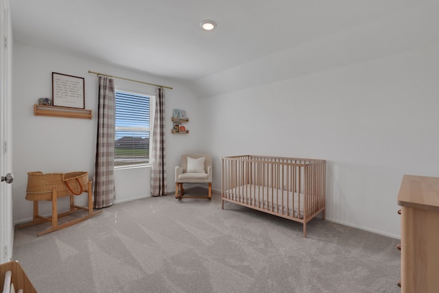 carpeted bedroom featuring vaulted ceiling, a nursery area, recessed lighting, and baseboards