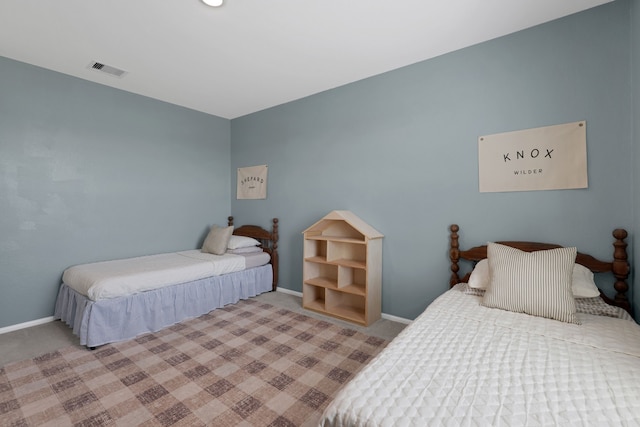 carpeted bedroom featuring baseboards and visible vents