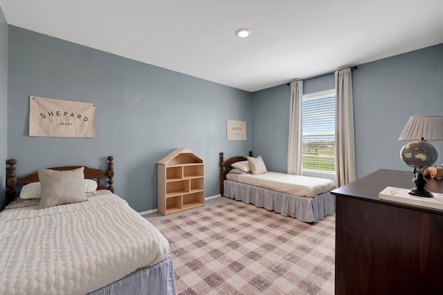 bedroom featuring baseboards and light carpet