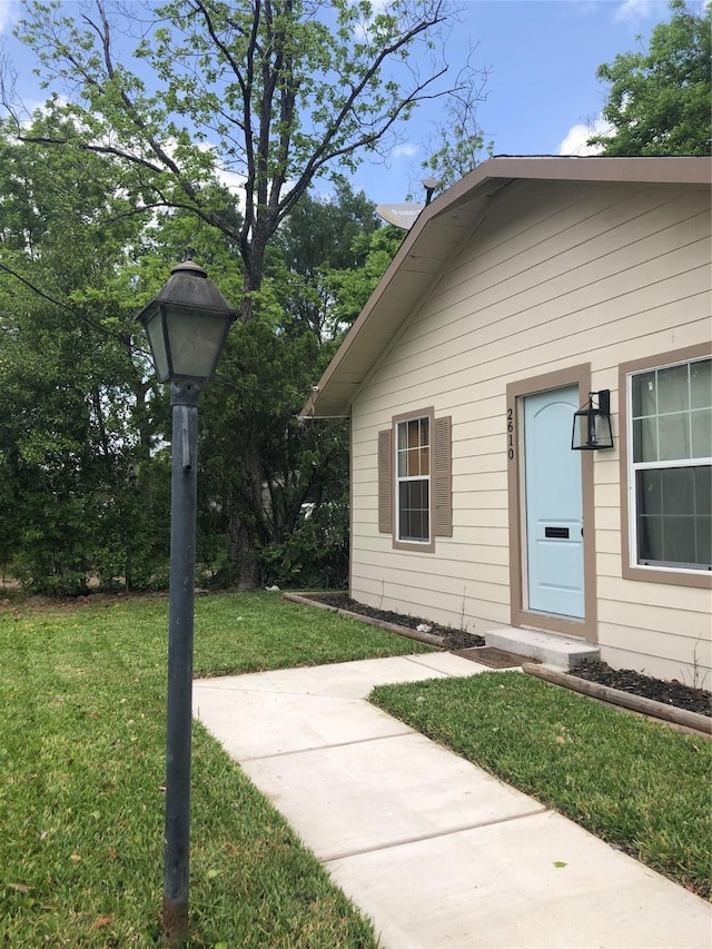 doorway to property featuring a yard