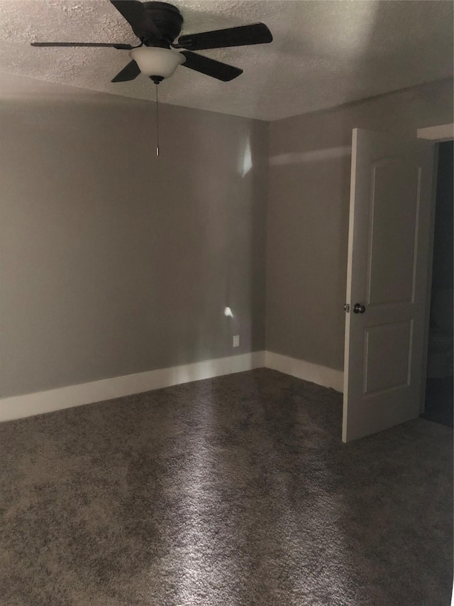 unfurnished room with a ceiling fan, baseboards, and a textured ceiling