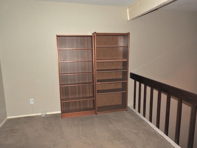 carpeted empty room with baseboards