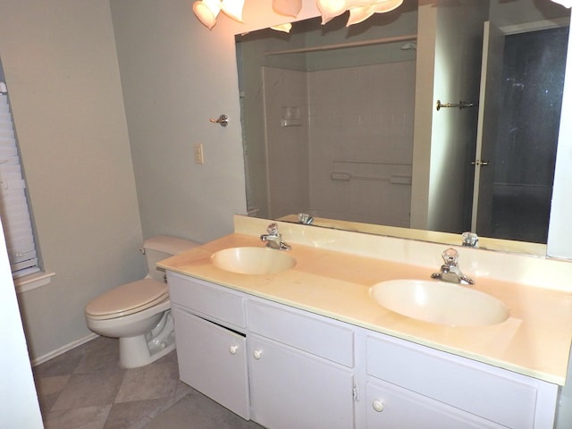 full bath featuring a sink, toilet, double vanity, and tile patterned flooring