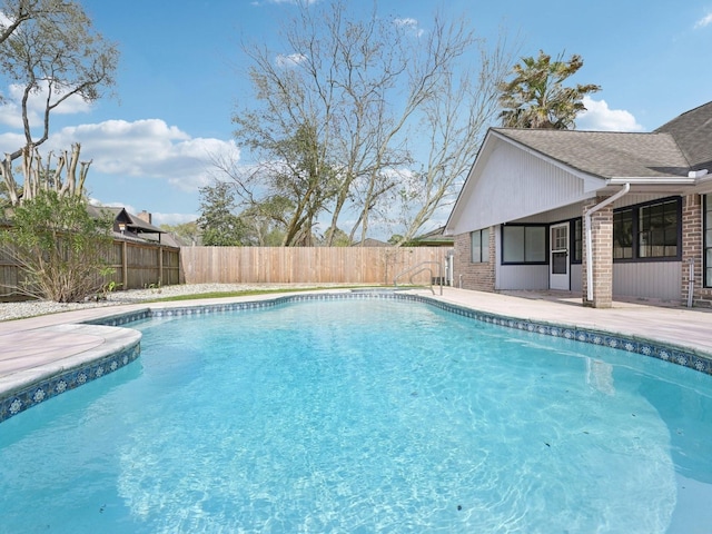 view of swimming pool with a patio area, a fenced in pool, and a fenced backyard