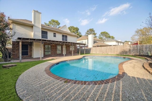 view of swimming pool featuring a lawn, a fenced in pool, a fenced backyard, and a patio area