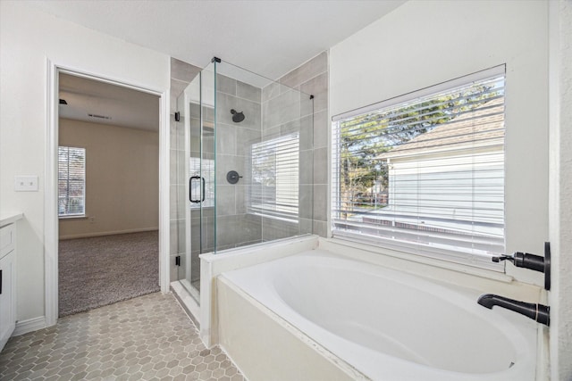 full bathroom with vanity, a shower stall, plenty of natural light, and a bath