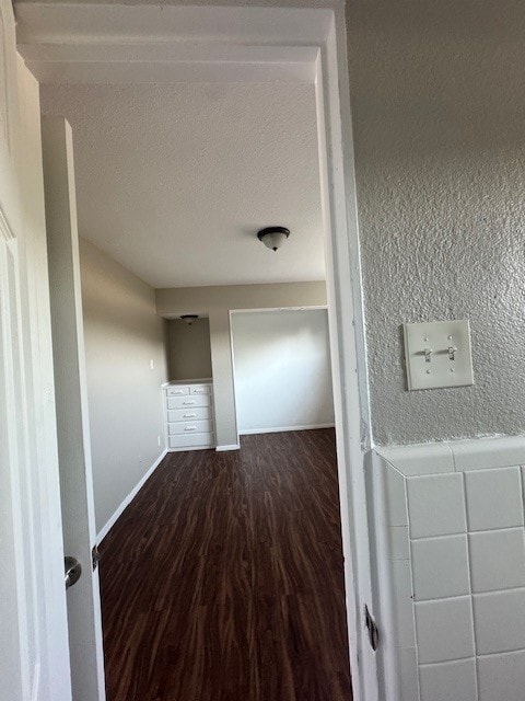4706 Yellowstone Blvd, Houston, TX 77021 - corridor with baseboards, a textured ceiling, wood finished floors, and a textured wall
