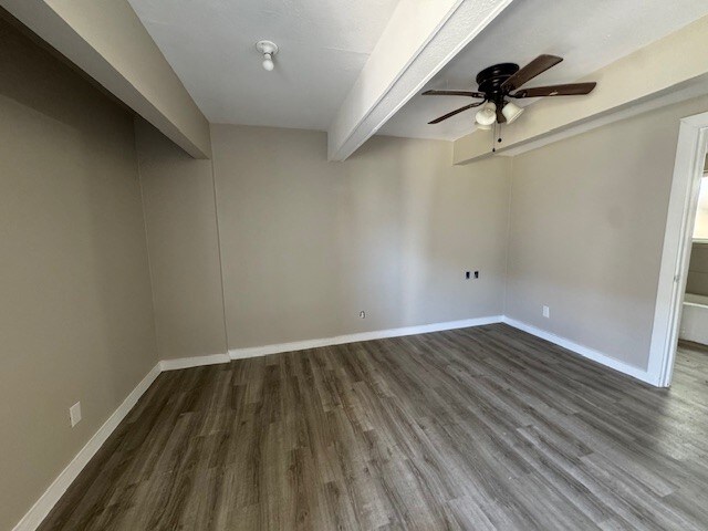 4706 Yellowstone Blvd, Houston, TX 77021 - spare room with wood finished floors, beamed ceiling, a ceiling fan, and baseboards