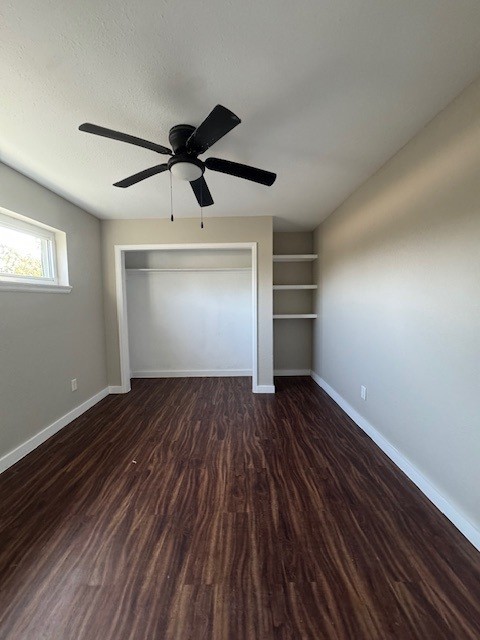 4706 Yellowstone Blvd, Houston, TX 77021 - unfurnished bedroom with baseboards, a textured ceiling, wood finished floors, and a ceiling fan