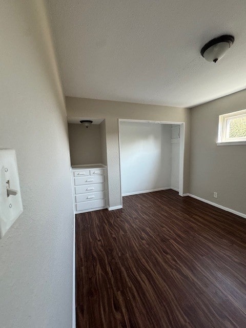 4706 Yellowstone Blvd, Houston, TX 77021 - unfurnished bedroom featuring a closet, baseboards, a textured ceiling, and wood finished floors