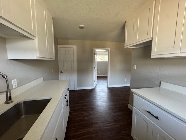 4706 Yellowstone Blvd, Houston, TX 77021 - kitchen with white cabinetry, a textured ceiling, and a sink