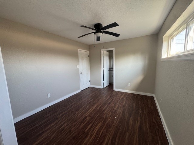 4706 Yellowstone Blvd, Houston, TX 77021 - unfurnished room with baseboards, a textured ceiling, dark wood finished floors, and a ceiling fan