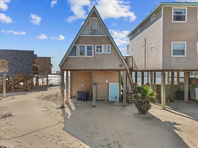 109 Beach Dr, Surfside Beach, TX 77541 - rear view of property featuring stairway