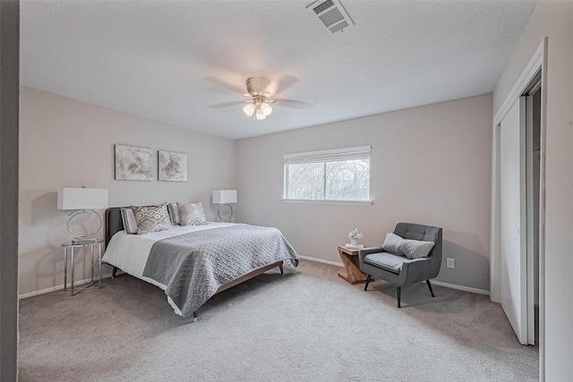 bedroom with visible vents, baseboards, a ceiling fan, and carpet floors
