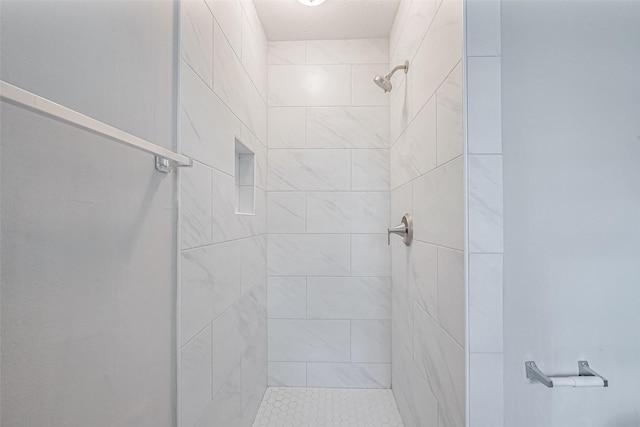 bathroom featuring tiled shower