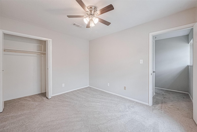 unfurnished bedroom featuring visible vents, ceiling fan, carpet flooring, and a closet