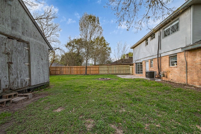 view of yard featuring a patio, a fenced backyard, and central AC