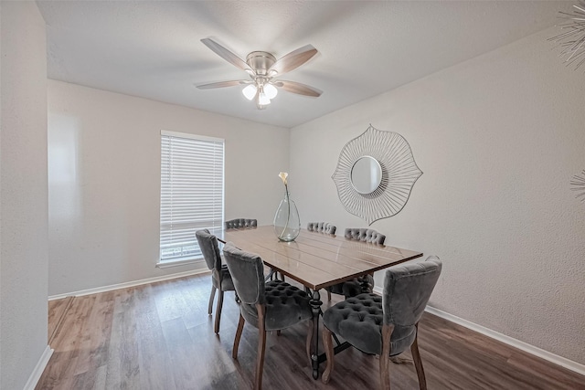 dining room featuring wood finished floors, baseboards, a ceiling fan, and plenty of natural light