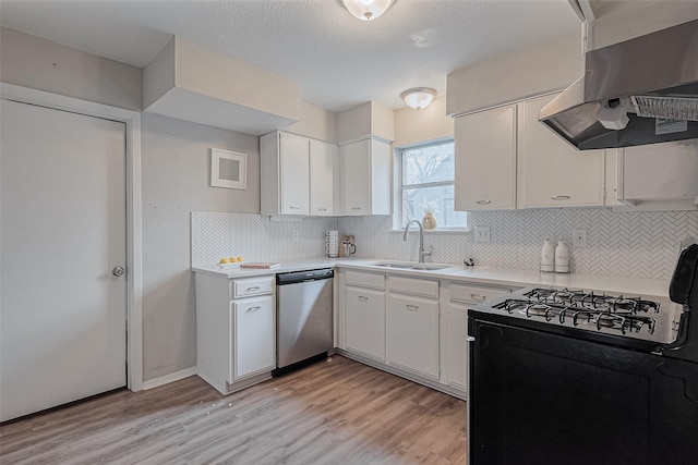 kitchen with exhaust hood, dishwasher, a sink, light countertops, and black gas range oven
