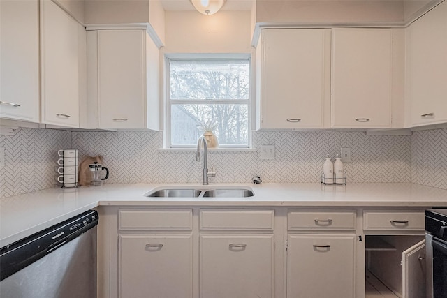 kitchen with a sink, white cabinets, decorative backsplash, and dishwasher